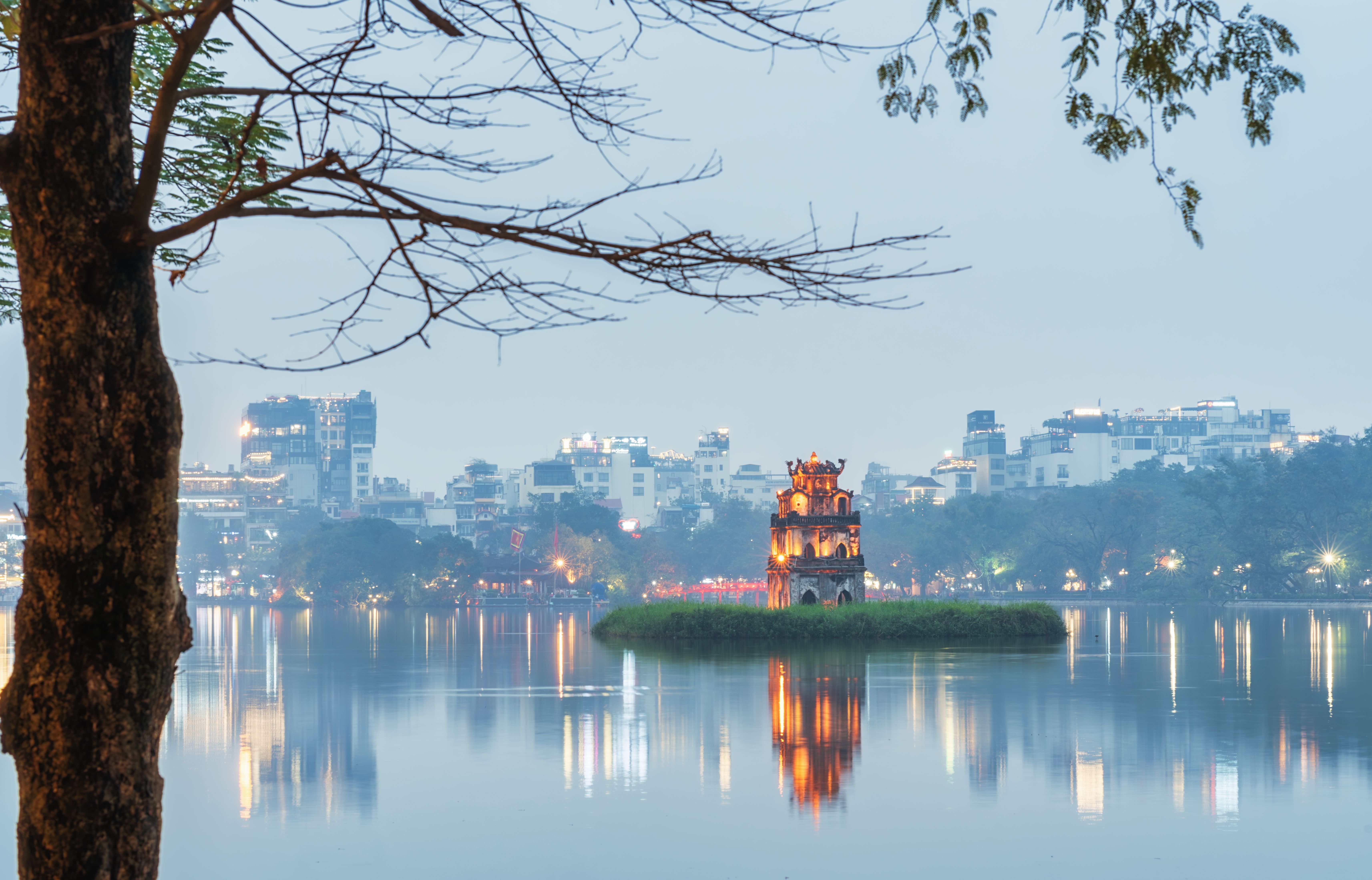 Hanoi lakeside neighbourhood and modern skyline at blue hour